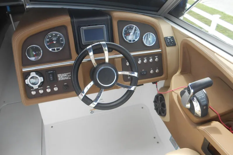 Slide: The Image of 2015 Cobalt 296 boat dashboard with steering wheel and control panel. - 12