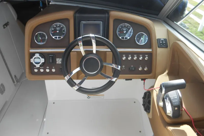 Slide: The Image of Steering console of a 2015 Cobalt 296 boat with gauges and controls. - 18