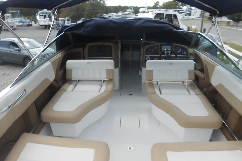 Slide: The Image of 2015 Cobalt 296 boat interior with beige and white seating, dashboard view. - 7