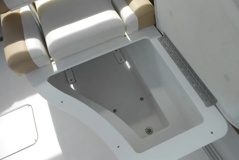Slide: The Image of 2015 Cobalt 296 boat interior storage compartment with beige and white seating. - 9