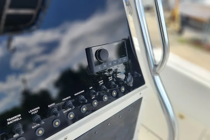 Slide: The Image of Control panel of a 2007 Triton 2895 CC boat with various switches and knobs. - 10