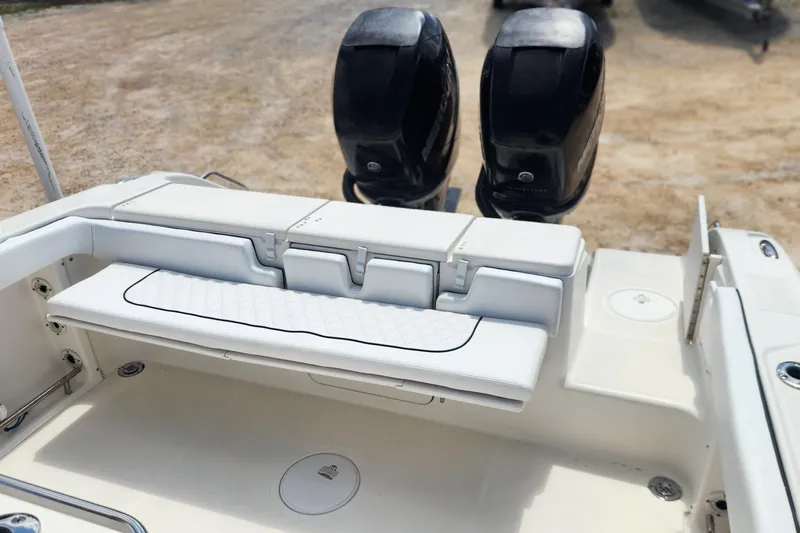 Slide: The Image of 2007 Triton 2895 CC boat interior with dual engines and white seating. - 11