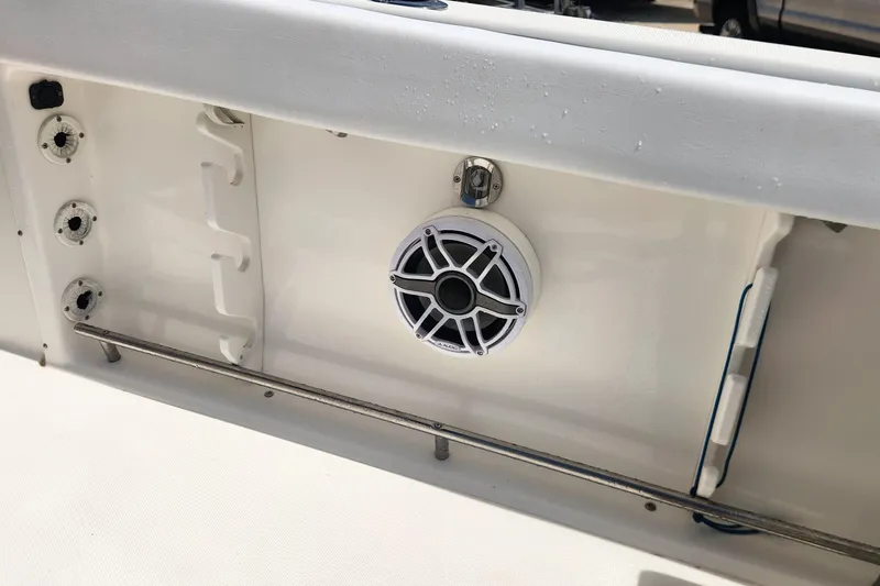 Slide: The Image of 2007 Triton 2895 CC boat interior with mounted speaker and rod holders. - 16