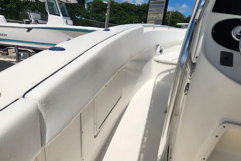 Slide: The Image of 2007 Triton 2895 CC boat interior with white seating and control panel. - 18