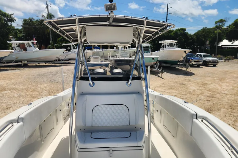Slide: The Image of 2007 Triton 2895 CC boat with T-top, parked on a sunny day at a marina. - 22