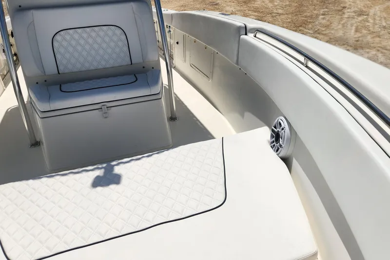 Slide: The Image of 2007 Triton 2895 CC boat interior with white cushioned seating and speaker. - 23