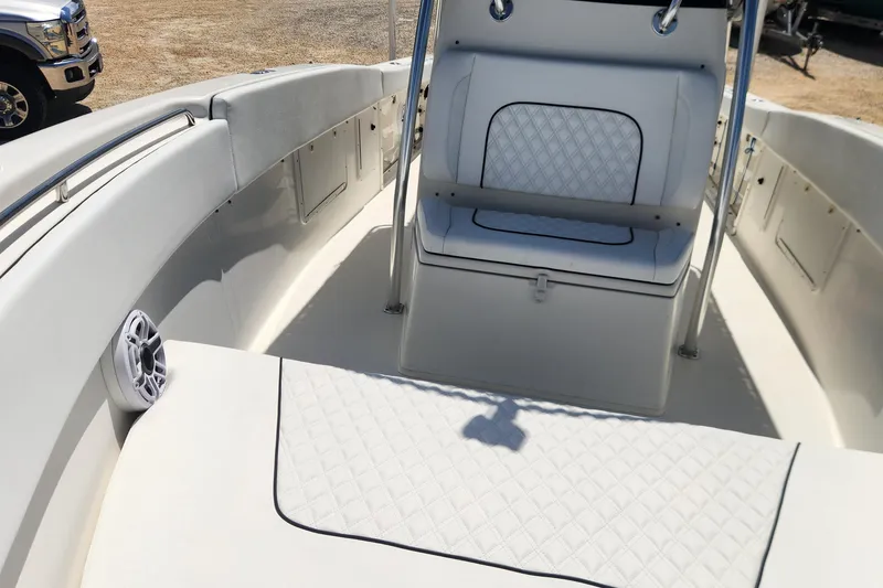 Slide: The Image of 2007 Triton 2895 CC boat interior with white cushioned seating and speaker. - 24
