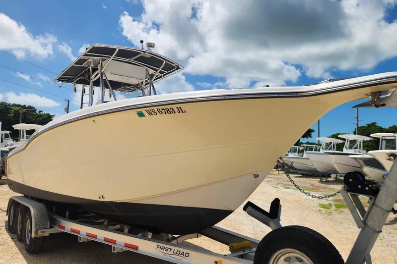 Slide: The Image of 2007 Triton 2895 CC boat on trailer under blue sky. - 3