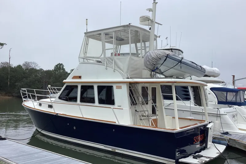 The Image of 2005 Sabre Flybridge yacht docked, featuring a sleek design and spacious upper deck. - 0