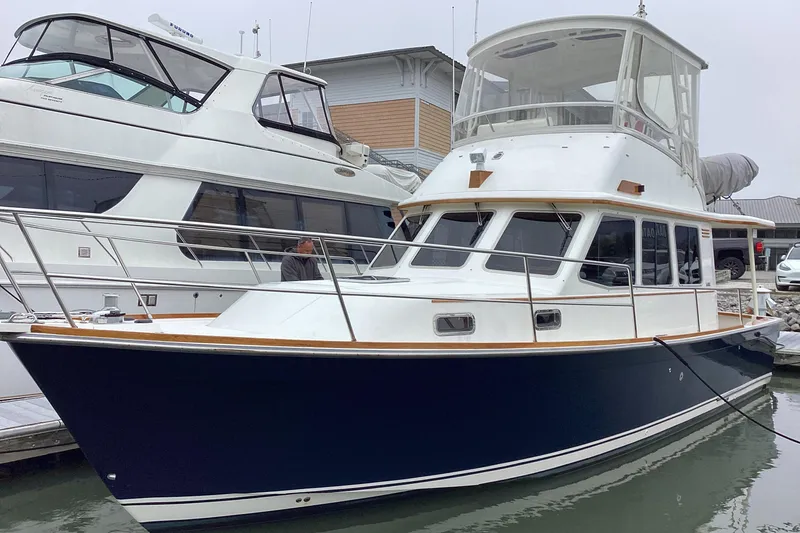 Slide: The Image of 2005 Sabre Flybridge yacht docked at marina, featuring sleek design and spacious upper deck. - 1