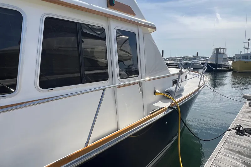 Slide: The Image of 2005 Sabre Flybridge yacht docked at marina with power cable connected. - 12