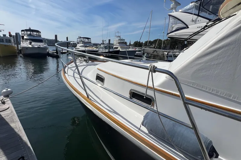 Slide: The Image of 2005 Sabre Flybridge yacht docked at a marina under clear blue skies. - 14