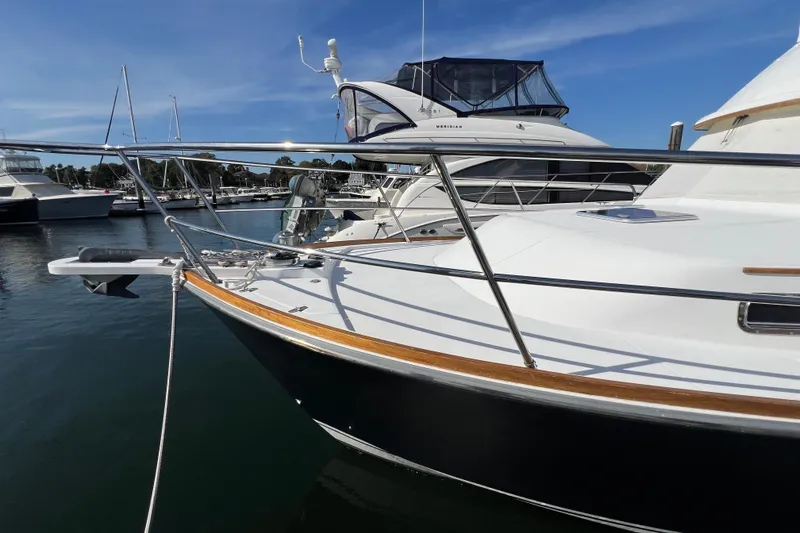 Slide: The Image of 2005 Sabre Flybridge yacht docked in marina under clear blue sky. - 16