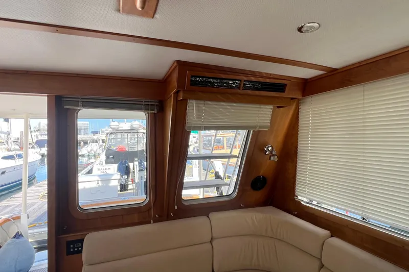 Slide: The Image of Interior of 2005 Sabre Flybridge yacht with beige seating and marina view. - 19