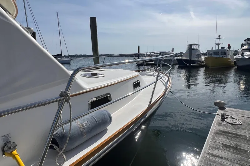 Slide: The Image of 2005 Sabre Flybridge yacht docked at marina, sunny day, calm waters. - 2