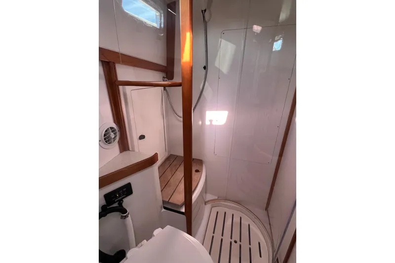 Slide: The Image of 2005 Sabre Flybridge bathroom with wooden accents and shower area. - 24