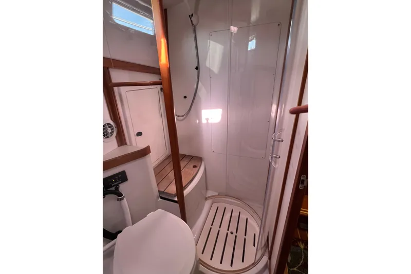 Slide: The Image of 2005 Sabre Flybridge yacht bathroom with shower, wooden accents, and modern fixtures. - 27