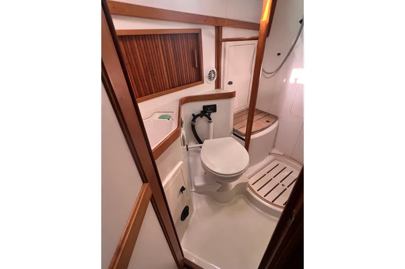 Slide: The Image of 2005 Sabre Flybridge yacht bathroom with wooden accents and modern fixtures. - 28