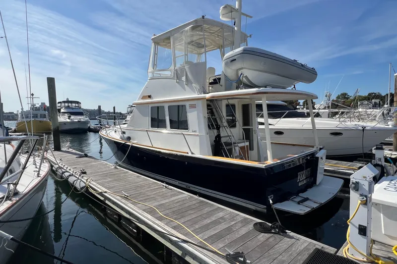 Slide: The Image of 2005 Sabre Flybridge yacht docked at marina under clear blue sky. - 3