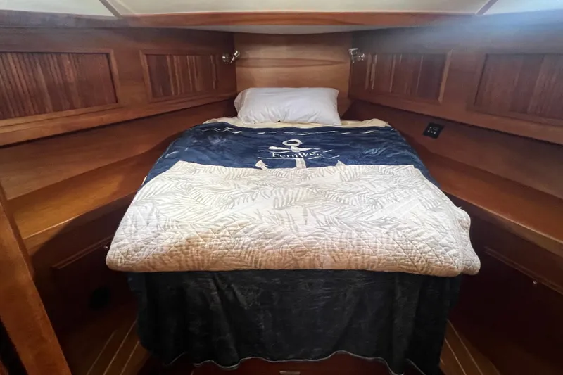 Slide: The Image of Cozy cabin interior of 2005 Sabre Flybridge with wooden paneling and comfortable bedding. - 31