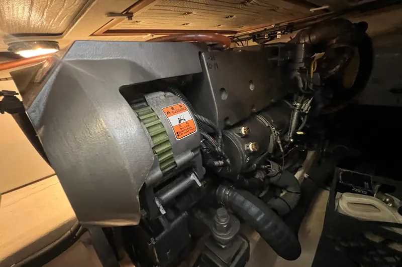 Slide: The Image of Engine compartment of a 2005 Sabre Flybridge boat, showcasing mechanical components and wiring. - 37