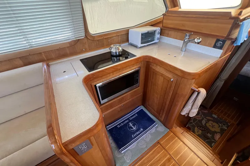 Slide: The Image of 2005 Sabre Flybridge yacht kitchen with stove, microwave, and sink. - 43