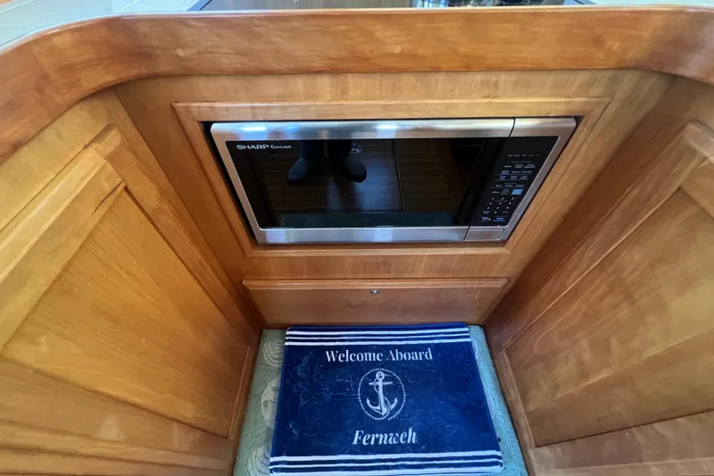 Slide: The Image of 2005 Sabre Flybridge interior with built-in microwave and welcome mat. - 44