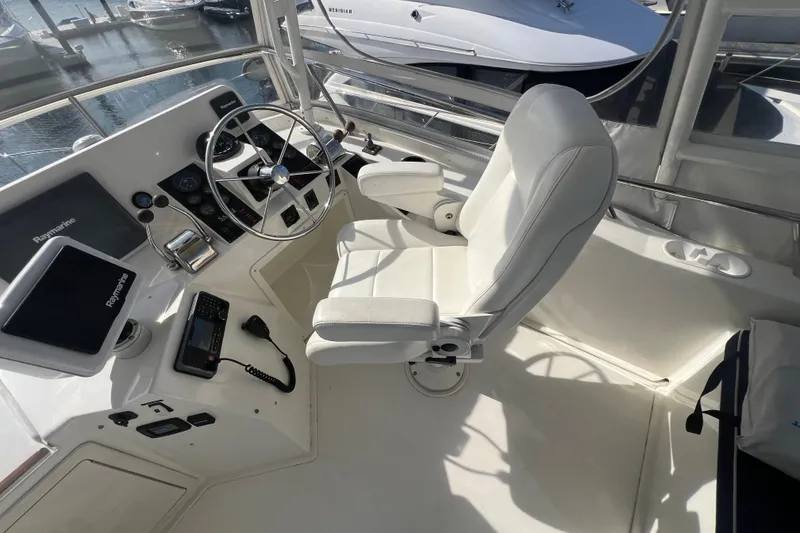 Slide: The Image of 2005 Sabre Flybridge helm with white captain's chair and navigation equipment. - 49
