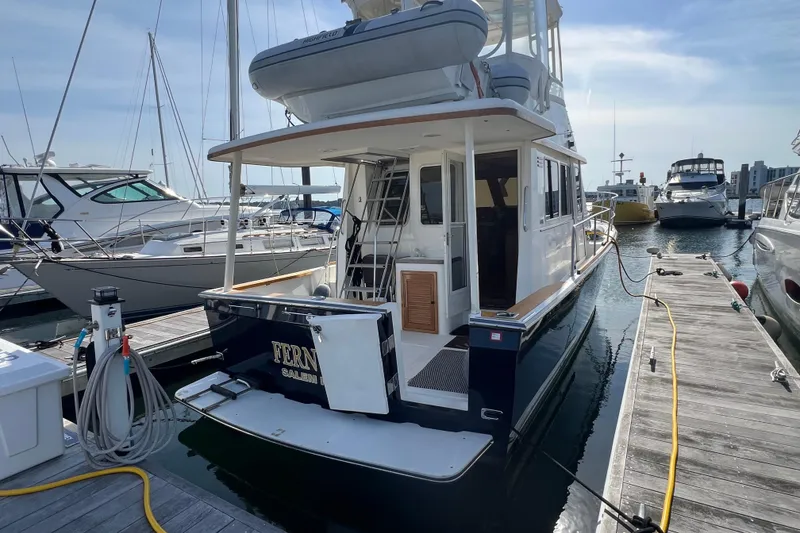 Slide: The Image of 2005 Sabre Flybridge yacht docked at marina, rear view with ladder and equipment. - 5