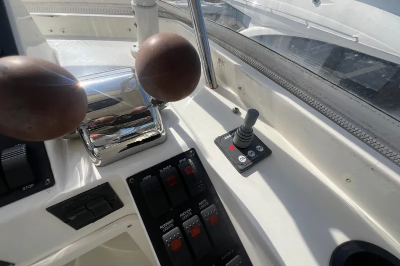 Slide: The Image of Control panel of a 2005 Sabre Flybridge boat with throttle and joystick. - 54