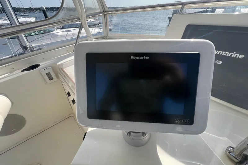 Slide: The Image of 2005 Sabre Flybridge with Raymarine navigation system, docked by the water. - 57