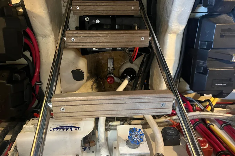 Slide: The Image of Engine compartment of a 2005 Sabre Flybridge boat with visible wiring and components. - 59
