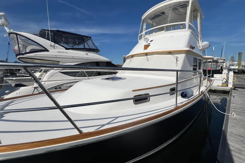 Slide: The Image of 2005 Sabre Flybridge yacht docked at marina under clear blue sky. - 6