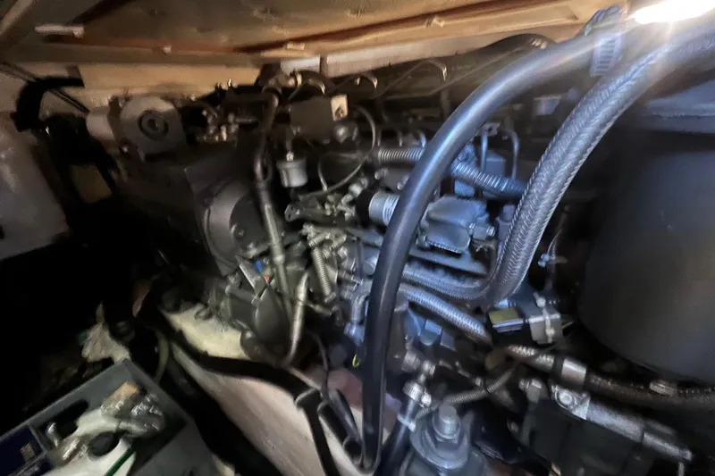 Slide: The Image of Engine compartment of a 2005 Sabre Flybridge boat, showcasing intricate mechanical components. - 60