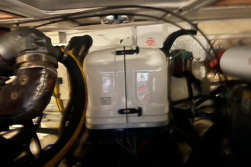 Slide: The Image of Engine room of a 2005 Sabre Flybridge boat with visible components and wiring. - 62