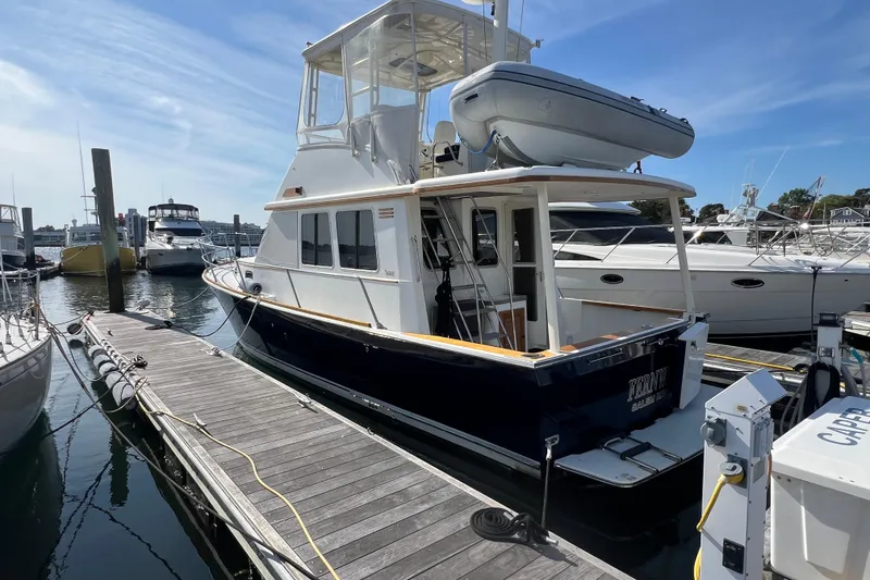 Slide: The Image of 2005 Sabre Flybridge yacht docked at marina under clear blue sky. - 7