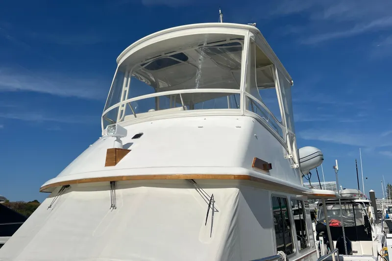Slide: The Image of 2005 Sabre Flybridge yacht with white exterior, docked under a clear blue sky. - 9
