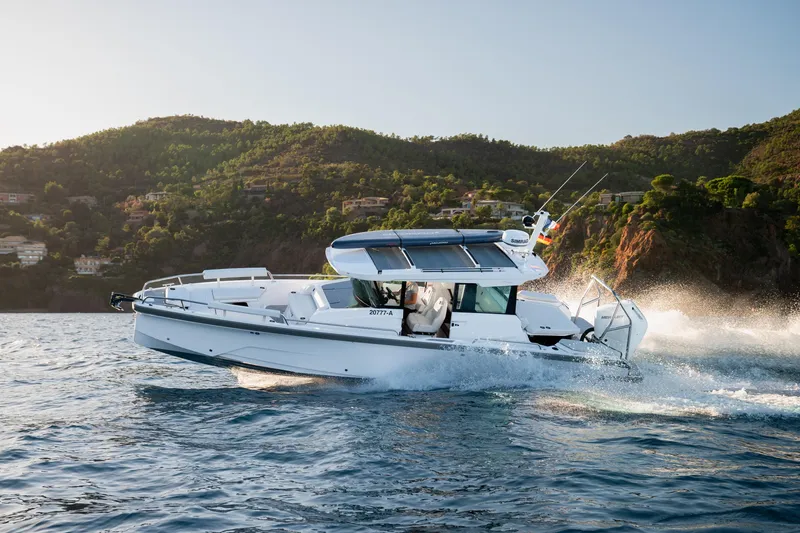 The Image of 2026 Axopar 29 XC boat cruising on scenic coastal waters. - 0