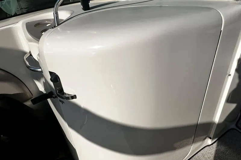 Slide: The Image of 2003 Sea Ray 220 Sundeck boat interior detail with white panel and chrome handle. - 10