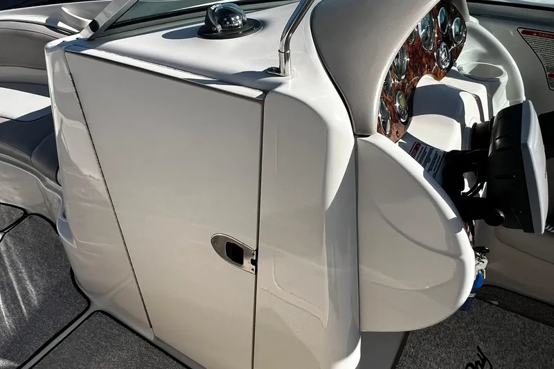 Slide: The Image of 2003 Sea Ray 220 Sundeck dashboard with steering wheel and instrument panel. - 12