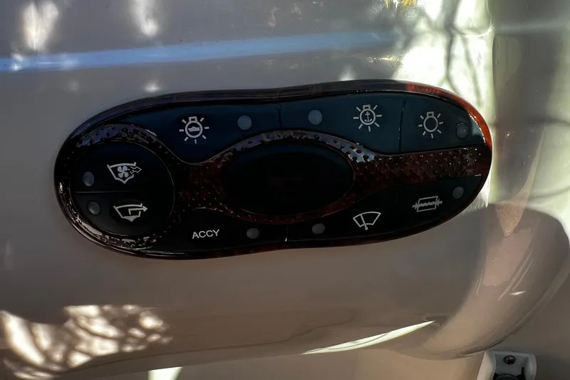 Slide: The Image of Control panel of a 2003 Sea Ray 220 Sundeck boat with various function buttons. - 19