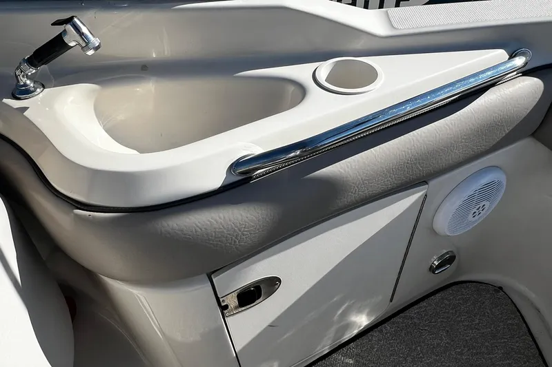 Slide: The Image of 2003 Sea Ray 220 Sundeck boat sink with faucet and storage compartment. - 22