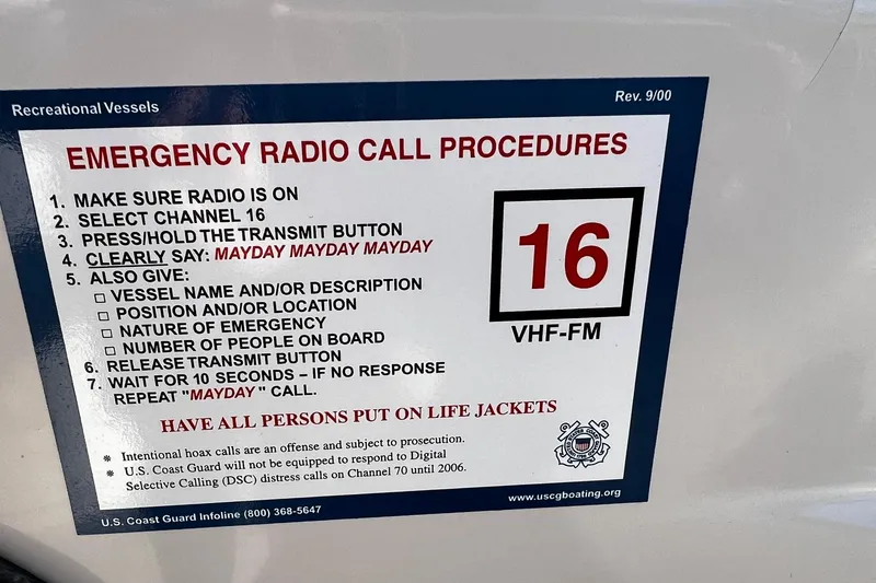 Slide: The Image of Emergency radio call procedures on 2003 Sea Ray 220 Sundeck, featuring channel 16 instructions. - 23