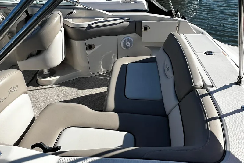 Slide: The Image of 2003 Sea Ray 220 Sundeck interior with cushioned seating and water view. - 4