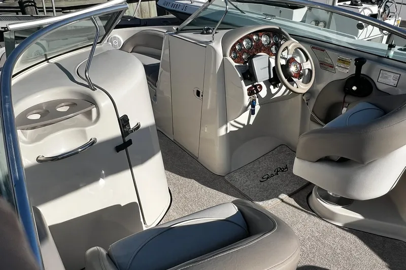 Slide: The Image of 2003 Sea Ray 220 Sundeck interior with steering wheel and seating area. - 5