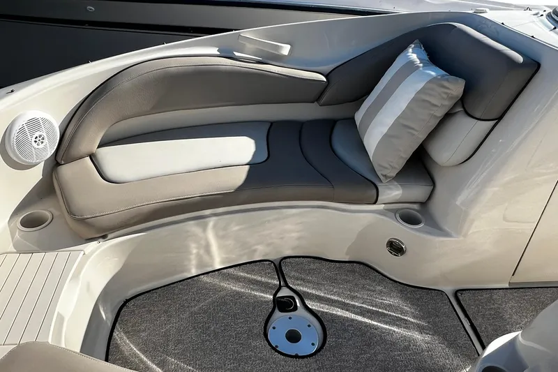 Slide: The Image of 2003 Sea Ray 220 Sundeck interior with cushioned seating and striped pillow. - 6