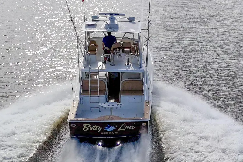 Slide: The Image of 2008 Ocean Yachts 37 Billfish cruising on water, rear view with wake. - 11