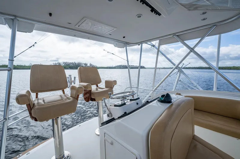 Slide: The Image of Interior view of 2008 Ocean Yachts 37 Billfish, featuring helm chairs and water backdrop. - 17