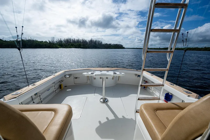 Slide: The Image of 2008 Ocean Yachts 37 Billfish boat deck with seating and ladder, overlooking serene waters. - 28
