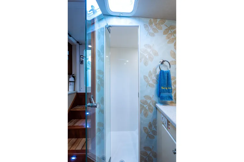 Slide: The Image of Bathroom interior of 2008 Ocean Yachts 37 Billfish, featuring a glass shower and floral wallpaper. - 35